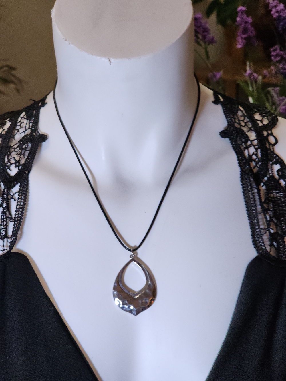 Silver Toned Teardrop Pendant Necklace On A Black Nylon Cord